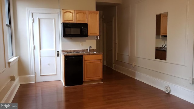 kitchen with sink, light brown cabinets, dark hardwood / wood-style flooring, and black appliances