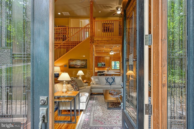 living room with sink, a healthy amount of sunlight, and hardwood / wood-style flooring