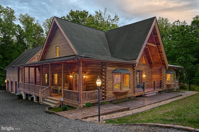 log-style house featuring a porch