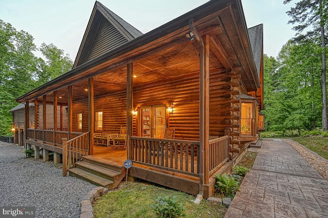 view of side of property featuring covered porch