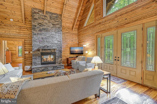 living room with a fireplace, hardwood / wood-style flooring, high vaulted ceiling, and wooden ceiling