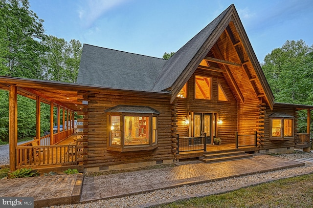 rear view of property with a porch