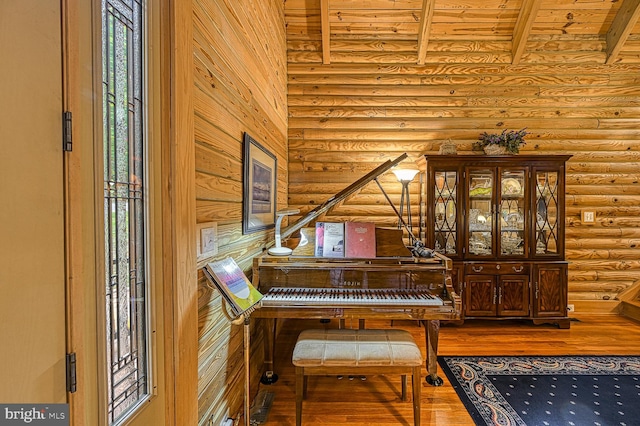 misc room featuring rustic walls, beamed ceiling, wood ceiling, and wood-type flooring