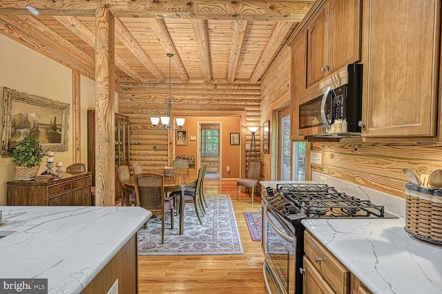 kitchen with rustic walls, hanging light fixtures, wooden ceiling, appliances with stainless steel finishes, and light wood-type flooring