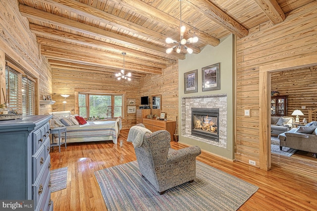 bedroom with beamed ceiling, wood ceiling, light hardwood / wood-style flooring, and an inviting chandelier