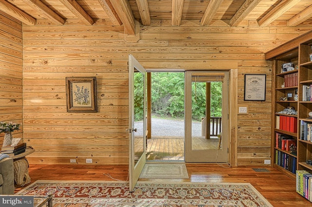 doorway to outside featuring hardwood / wood-style floors, wooden ceiling, and beamed ceiling