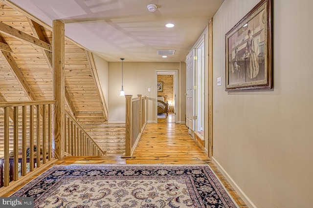 hallway with hardwood / wood-style flooring and wood ceiling