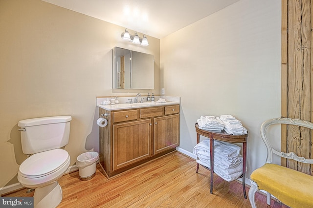 bathroom featuring vanity, toilet, and wood-type flooring