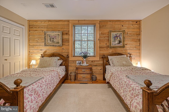 bedroom featuring wooden walls and a closet