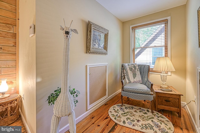 sitting room with hardwood / wood-style flooring