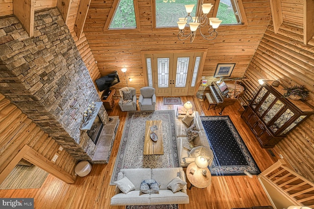 living room featuring an inviting chandelier, hardwood / wood-style flooring, high vaulted ceiling, and plenty of natural light