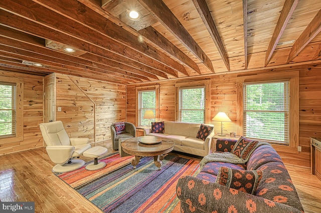 living room with beam ceiling, wooden walls, hardwood / wood-style floors, and wood ceiling