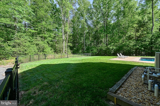 view of yard featuring a fenced in pool and a patio