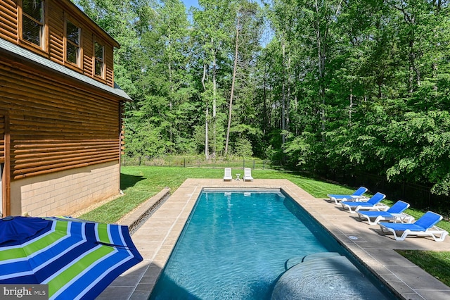 view of pool featuring a yard and a patio