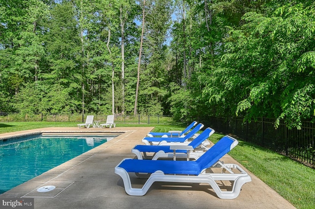 view of pool featuring a yard and a patio