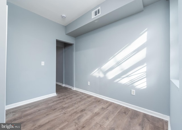 unfurnished room with hardwood / wood-style floors