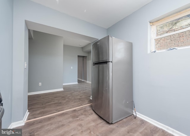 kitchen with stainless steel refrigerator and hardwood / wood-style floors