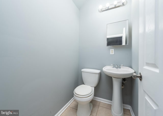 bathroom with toilet and tile floors