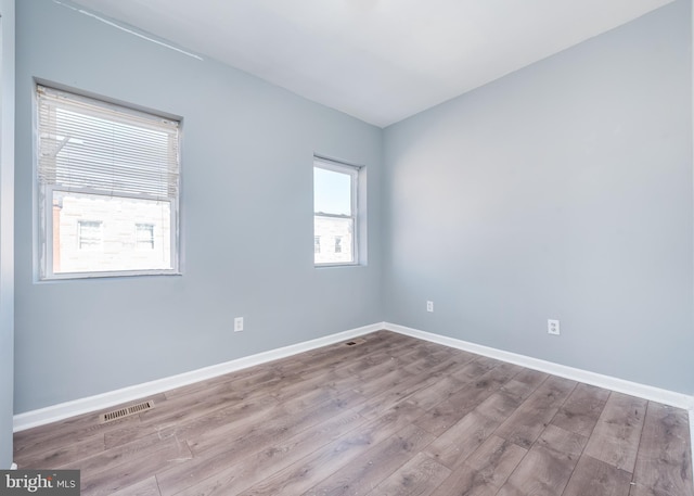 empty room with hardwood / wood-style flooring