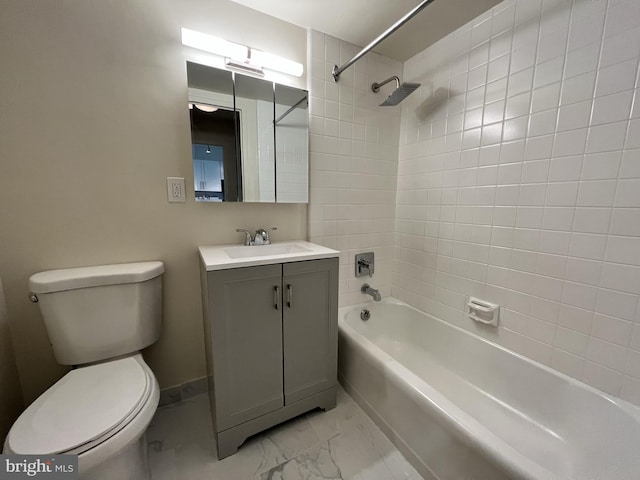 full bathroom featuring toilet, tiled shower / bath, and vanity