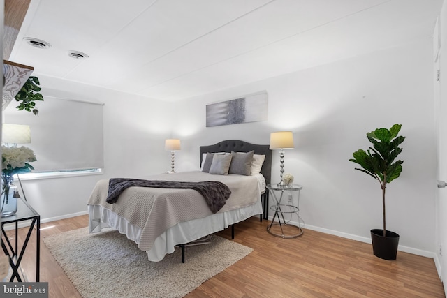 bedroom with hardwood / wood-style flooring