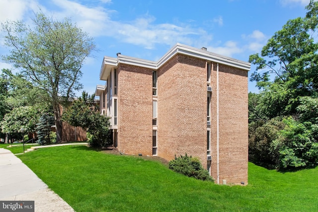 view of home's exterior with a lawn