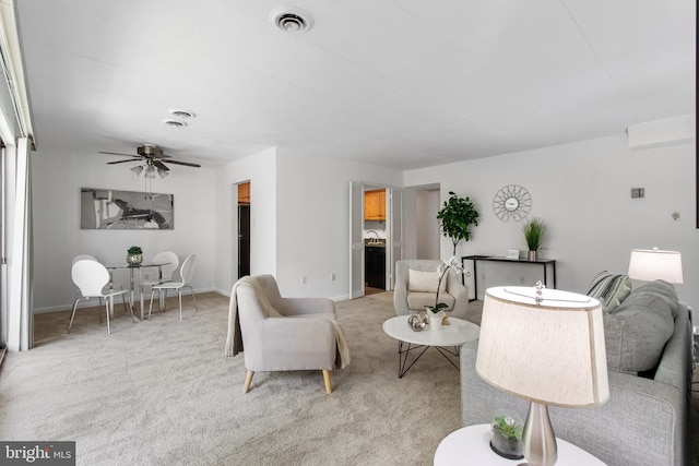 carpeted living room featuring ceiling fan