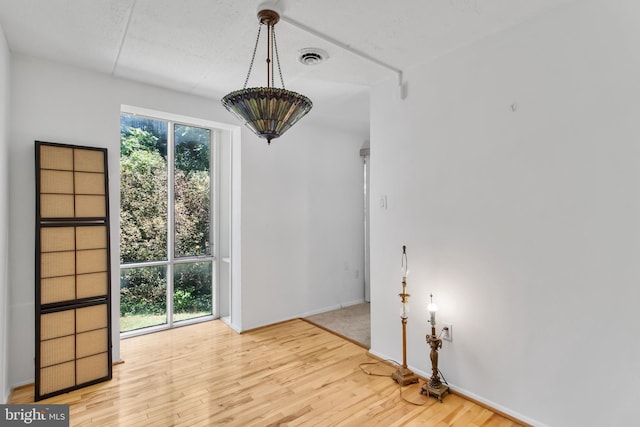 unfurnished room with wood-type flooring