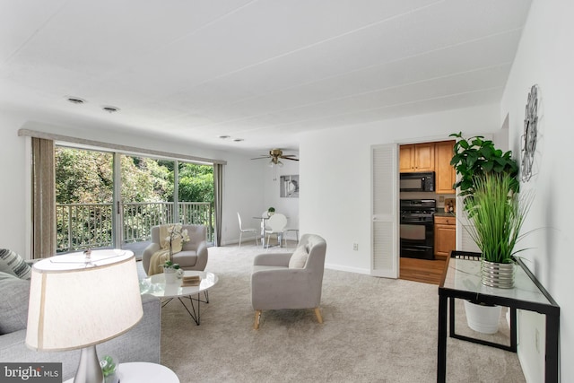 living room featuring ceiling fan and light carpet