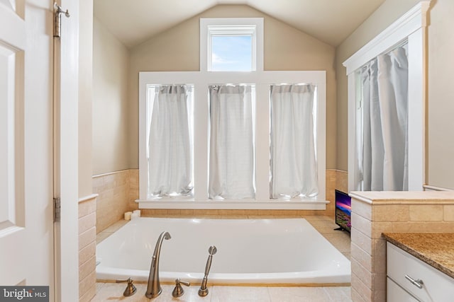 bathroom with vanity and vaulted ceiling