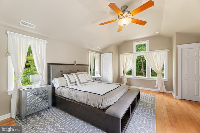 bedroom featuring ceiling fan, wood-type flooring, and vaulted ceiling