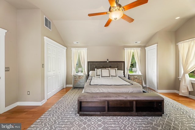 bedroom featuring ceiling fan, wood-type flooring, and vaulted ceiling