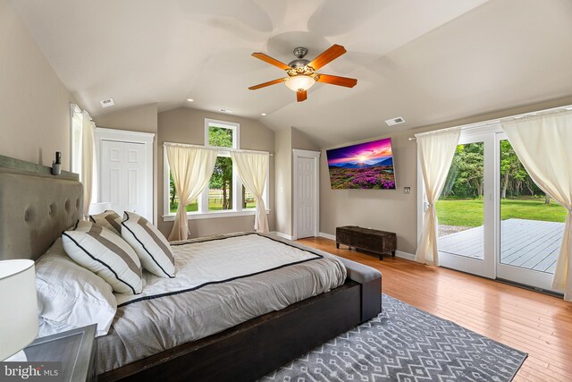 bedroom featuring hardwood / wood-style flooring, ceiling fan, access to exterior, and vaulted ceiling