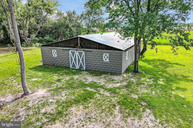 view of outbuilding with a lawn