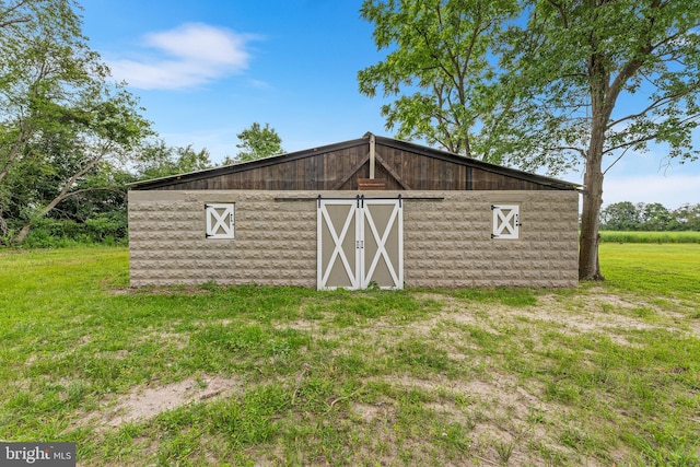 view of outdoor structure featuring a lawn