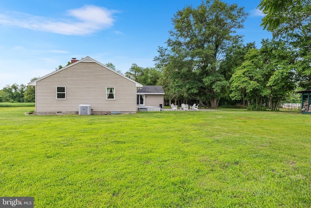 back of property featuring a lawn and central AC unit