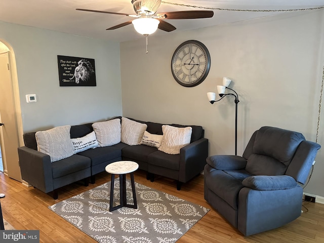 living room with ceiling fan and wood-type flooring