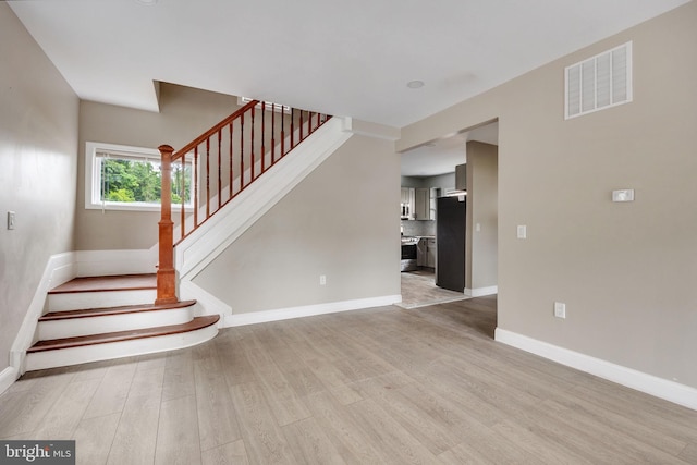 stairs featuring hardwood / wood-style floors