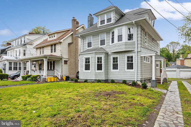 view of front of home featuring a front lawn and a porch