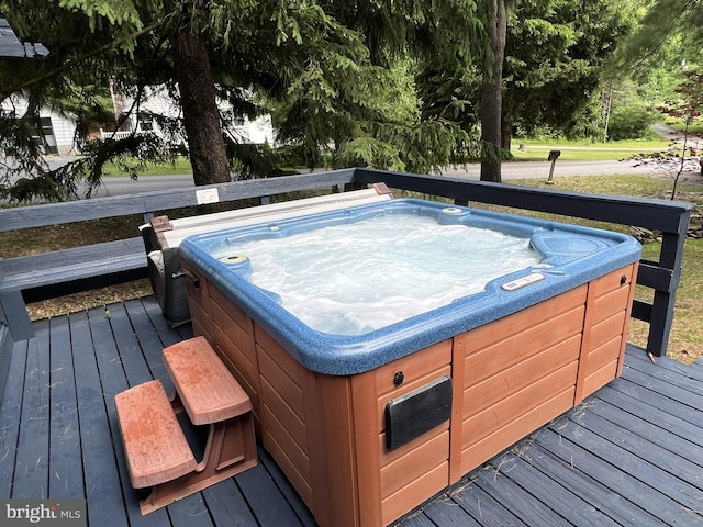 wooden terrace featuring a hot tub