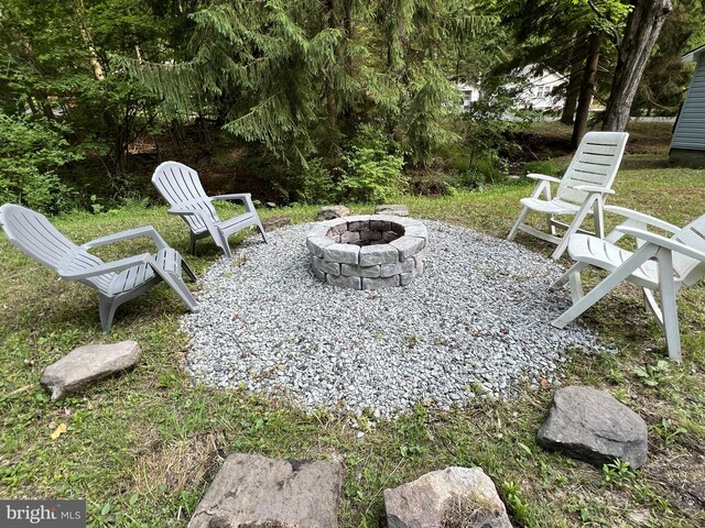 view of yard with a fire pit