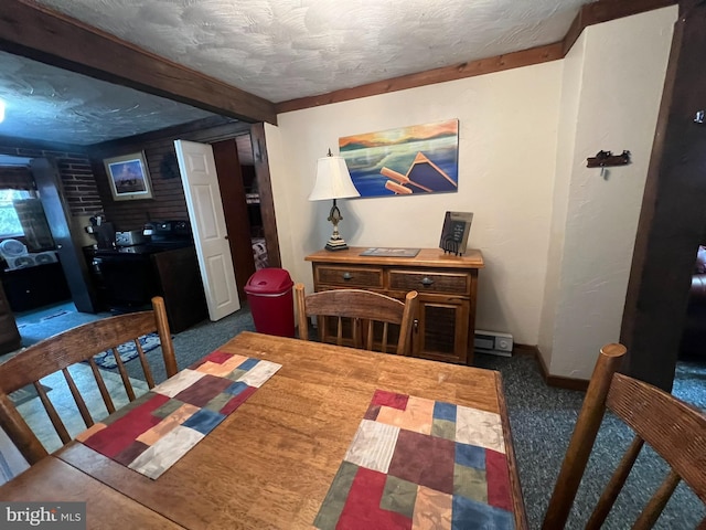 dining space featuring a baseboard heating unit, a textured ceiling, brick wall, and dark colored carpet