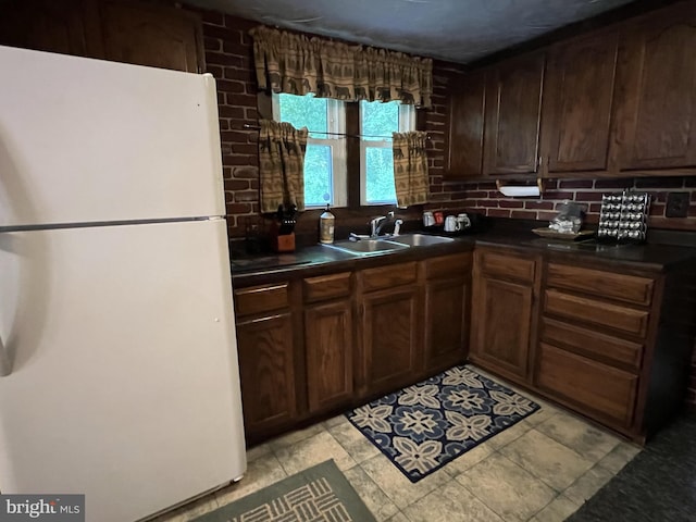 kitchen with sink, tasteful backsplash, light tile flooring, and white fridge