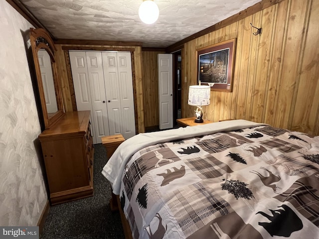 carpeted bedroom featuring wooden walls and a closet