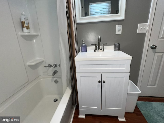 bathroom featuring hardwood / wood-style flooring, bathing tub / shower combination, and oversized vanity