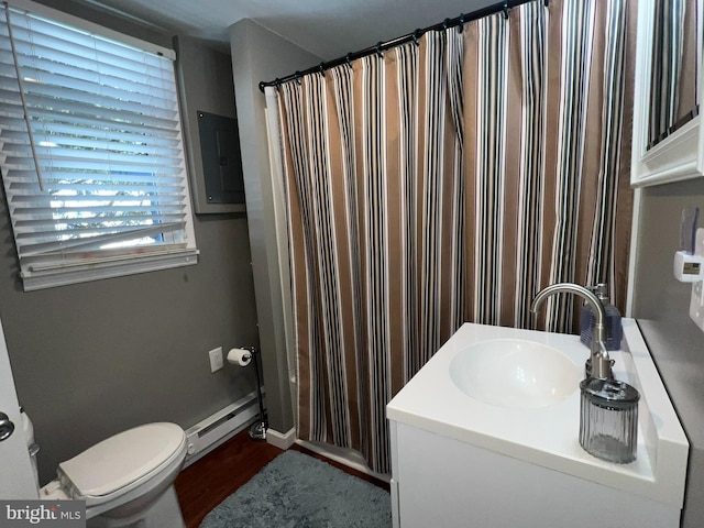 bathroom featuring baseboard heating, vanity, and toilet