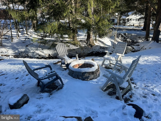 yard covered in snow featuring a fire pit