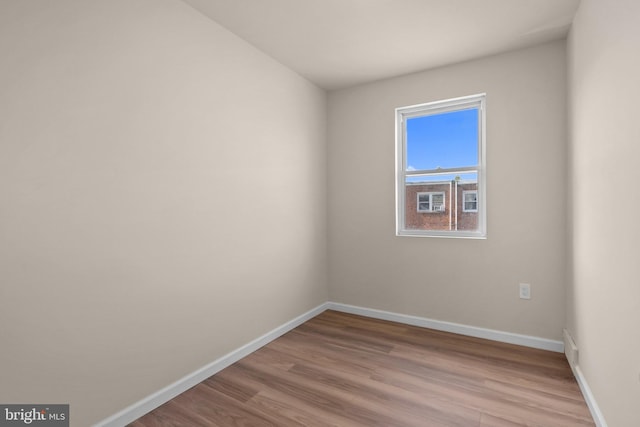 unfurnished room with hardwood / wood-style flooring