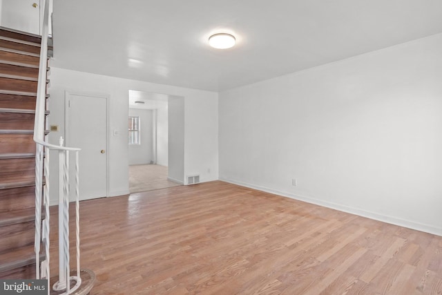 empty room with light hardwood / wood-style flooring