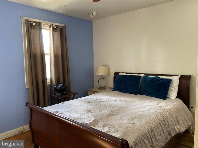 bedroom featuring wood finished floors and baseboards